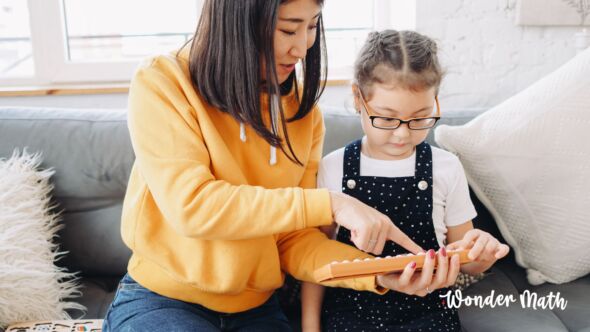 Mom helping her young child with math