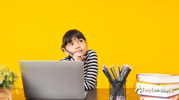 Young girl thinking at a desk.