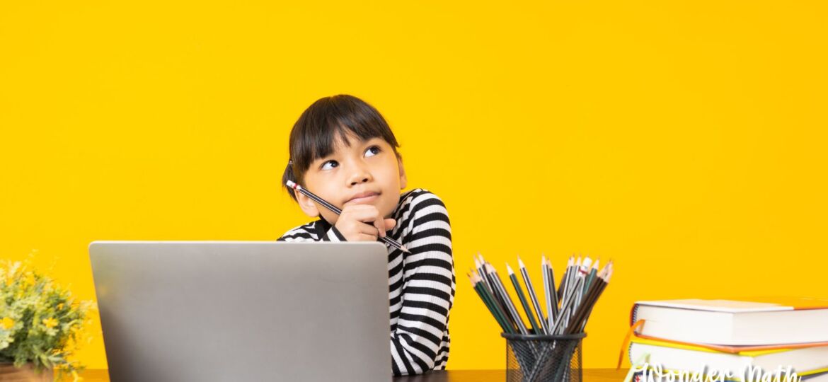 Young girl thinking at a desk.