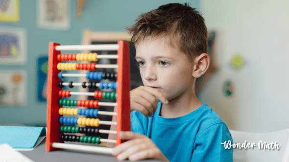 Young child contemplating a math problem and dealing with math anxiety.