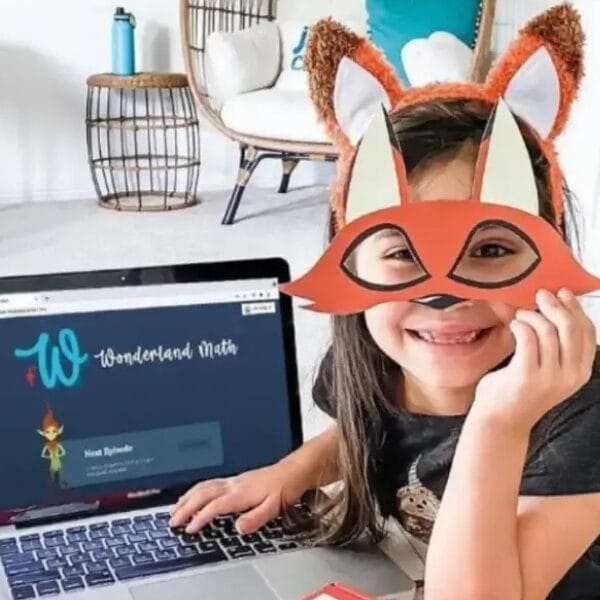 child with wondermath mask and program on laptop